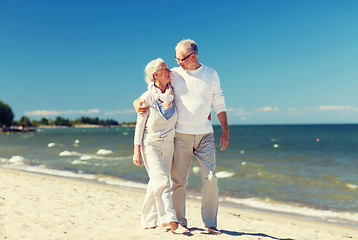 Image showing happy senior couple hugging on summer beach