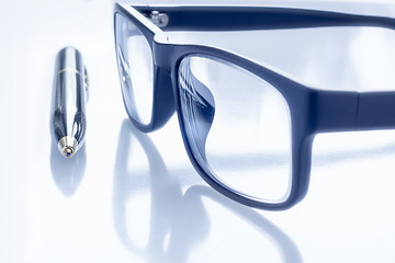 Image showing Black eye glasses and ballpoint pen