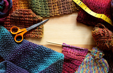 Image showing Border of knitting, wool, craft scissors and tape measure