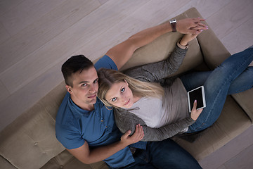 Image showing youg couple in living room with tablet top view