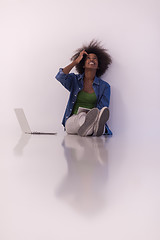 Image showing african american woman sitting on floor with laptop