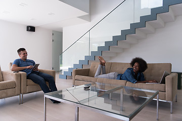 Image showing young multiethnic couple relaxes in the living room