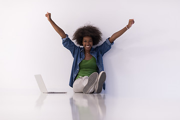 Image showing african american woman sitting on floor with laptop