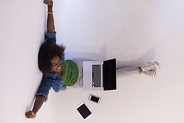 Image showing african american woman sitting on floor with laptop top view