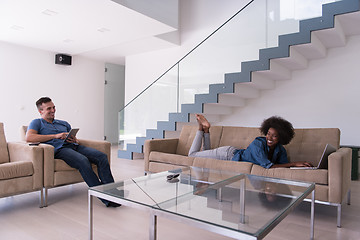 Image showing young multiethnic couple relaxes in the living room