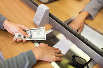 Image showing customer with money taking receipt from bank clerk