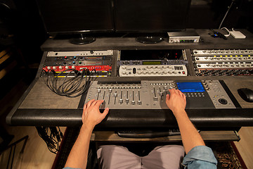 Image showing man using mixing console in music recording studio