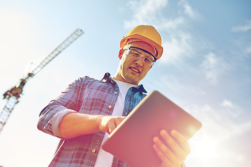 Image showing builder in hardhat with tablet pc at construction