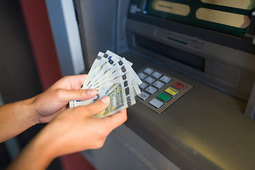 Image showing close up of hand withdrawing money at atm machine