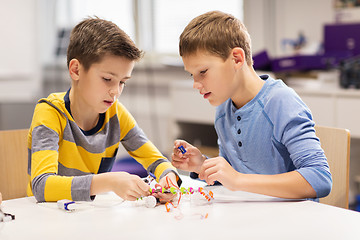 Image showing happy children building robots at robotics school
