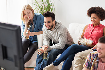 Image showing happy friends with popcorn watching tv at home