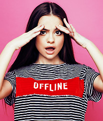 Image showing young pretty teenage woman emotional posing on pink background, fashion lifestyle people concept 