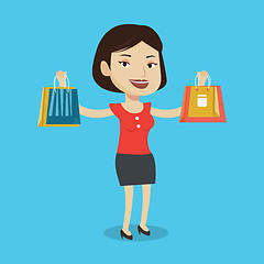 Image showing Happy woman holding shopping bags.