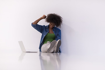 Image showing african american woman sitting on floor with laptop