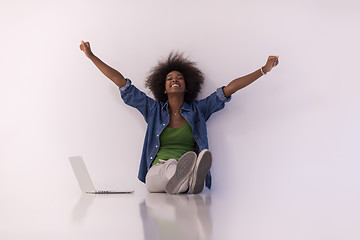 Image showing african american woman sitting on floor with laptop