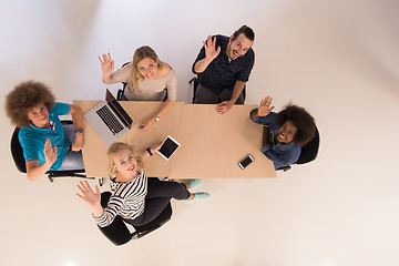 Image showing Multiethnic startup business team on meeting  top view