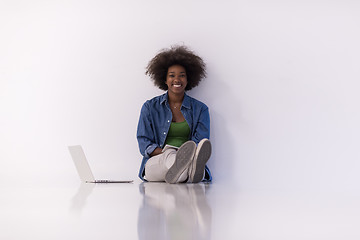 Image showing african american woman sitting on floor with laptop