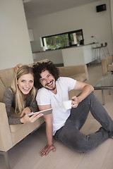 Image showing couple relaxing at  home with tablet computers