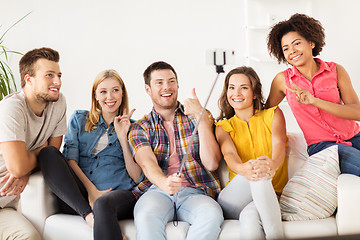 Image showing happy friends taking selfie by smartphone at home