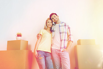 Image showing smiling couple with big boxes moving to new home