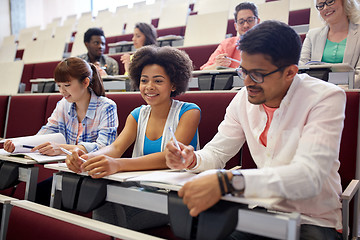 Image showing group of students with notebooks in lecture hall