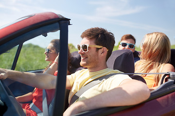 Image showing happy friends driving in cabriolet car