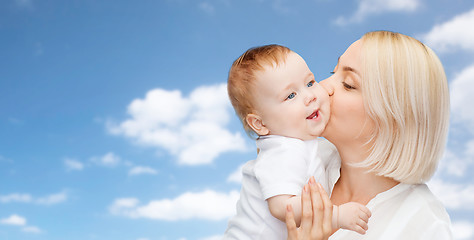 Image showing happy mother kissing adorable baby