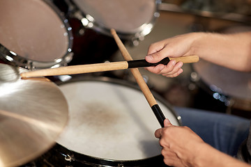 Image showing male musician playing drums and cymbals at concert