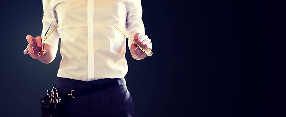 Image showing close up of male stylist with scissors at salon