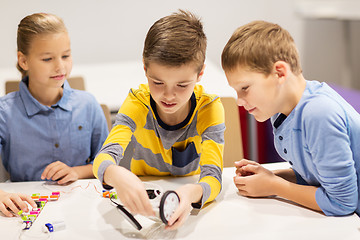 Image showing happy children building robots at robotics school