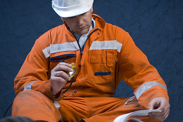 Image showing Engineer checking the plans