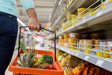 Image showing woman with food basket at grocery or supermarket