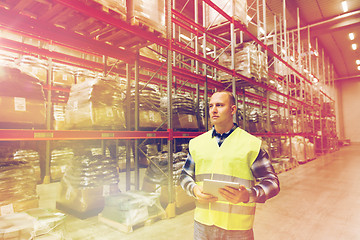 Image showing manual worker with tablet pc at warehouse