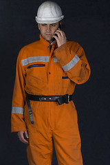 Image showing Worker talking on a cell phone