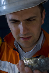 Image showing Chief miner inspecting mineral