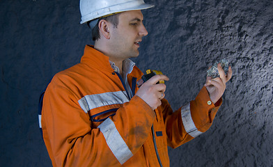 Image showing Engineer inspecting mineral