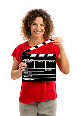 Image showing Happy mature woman holding a clapboard