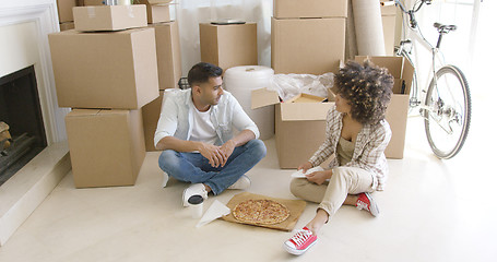 Image showing Young couple taking a break from moving house