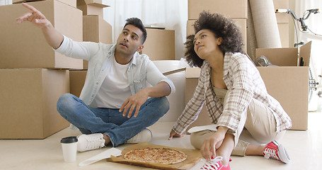 Image showing Young couple eating pizza and chatting