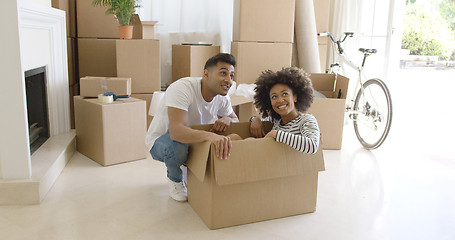 Image showing Happy young couple moving house together