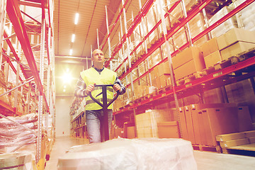 Image showing man carrying loader with goods at warehouse