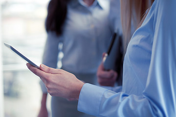 Image showing close up of business team with tablet pc in office