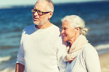 Image showing happy senior couple hugging on summer beach