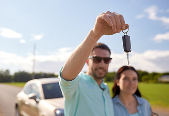 Image showing happy man and woman with car key outdoors