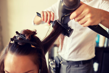 Image showing  close up of stylist making hairdo at salon