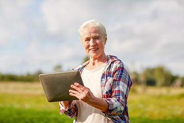 Image showing senior woman with tablet pc computer at county