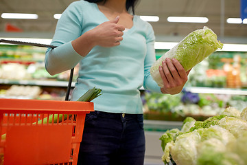 Image showing woman with basket and chinese cabbage at grocery