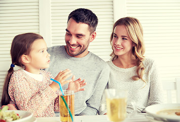 Image showing happy family having dinner at restaurant or cafe