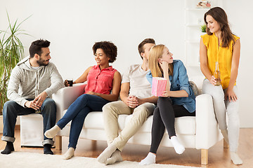 Image showing happy friends with popcorn and beer at home