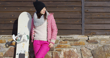 Image showing Pretty young woman with snowboard